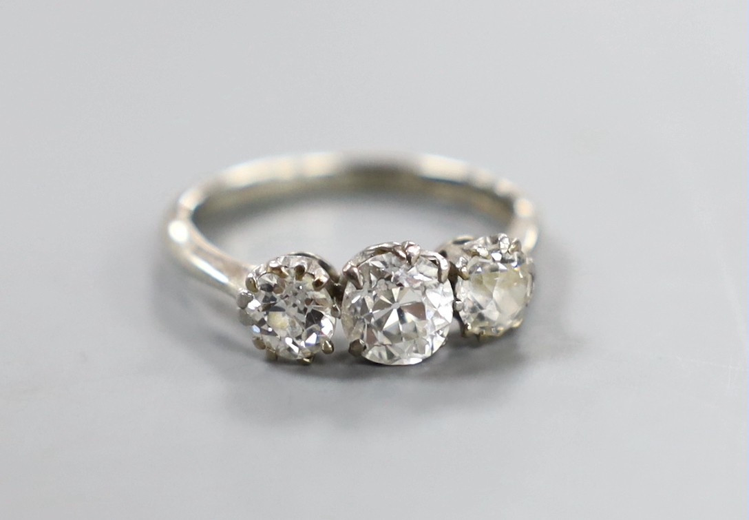 An 18ct, plat and three stone diamond ring, size K, gross weight 2.9 grams